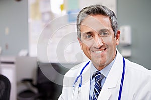 Portrait Of Doctor Working At Nurses Station