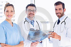 Portrait of doctors with xray report at medical office