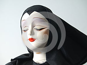 Portrait of doll in black habit