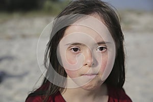 Portrait of down syndrome girl outside