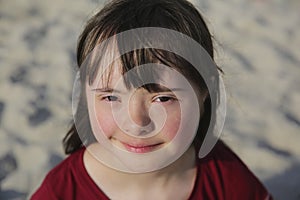 Portrait of down syndrome girl outside