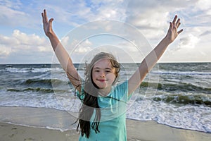 Portrait of down syndrome girl smiling on background of the sea