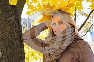 Portrait of dreaming blonde girl in park