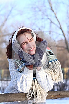 Portrait of dreaming girl in winter park outdoors