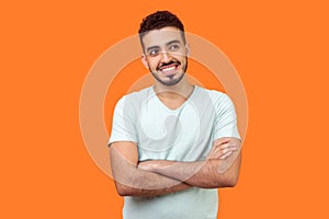 Portrait of dreamy thoughtful bearded man dreaming and thinking of pleasant memories. indoor studio shot isolated on orange