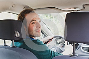 Portrait of driver in the car or taxi