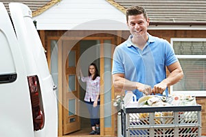 Portrait Of Driver Delivering Online Grocery Order To House