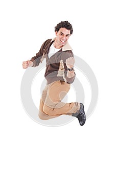 Portrait of ecstatic casual young man jumping with hands raised