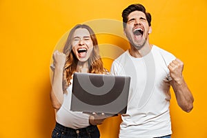 Portrait of ecstatic man and woman shouting and clenching fists