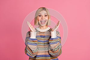 Portrait of ecstatic woman with bob hairdo dressed print sweater raising palms scream astonished staring isolated on