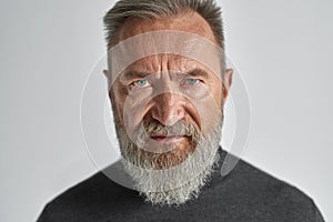 Portrait of ederly serious caucasian man in studio