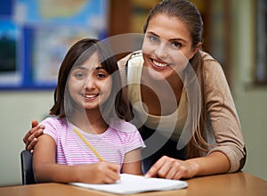 Portrait, education or school with a student and teacher in a classroom together for writing or child development. Study