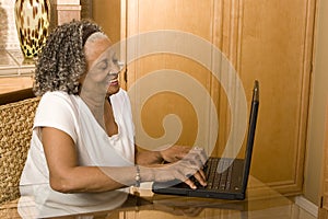 Portrait of an elderly African American woman on her computer.