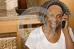 Portrait of an elderly African American woman on the phone.