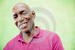 Portrait of elderly black man looking and smiling at camera