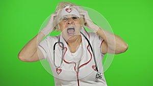 Portrait of elderly caucasian female doctor. Crazy and funny nurse