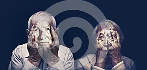 Portrait of an elderly couple with face closed by hands