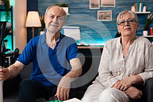 Portrait of elderly couple sitting together at home