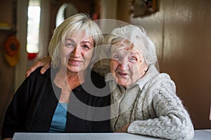 Portrait of an elderly happy woman with her adult daughter.