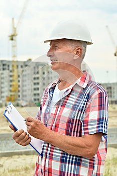 Portrait of an elderly man on a construction site