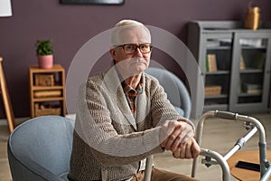 Elderly man using walker at home