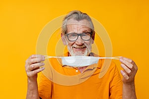 Portrait elderly man medical mask on the face protection close-up cropped view