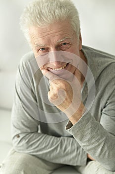 Portrait of an elderly man posing at home