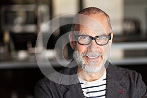 Portrait Of A Elderly Man Smiling At The Camera