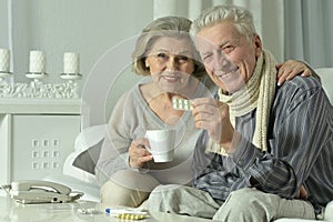 Portrait of elderly man and woman with flu.