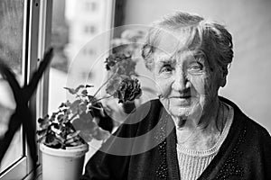 Portrait of an elderly woman on the balcony.
