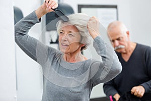 portrait elderly woman brushing hair