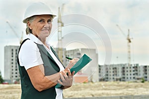 Portrait of an elderly woman on a construction site