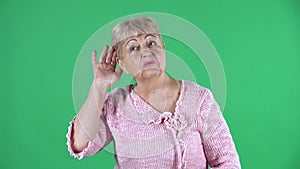 Portrait elderly woman holding hand near ear trying listen interesting news expressing communication concept and gossip