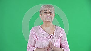 Portrait elderly woman looking at the camera with surprise and delight. Gray haired grandmother with short hair in a