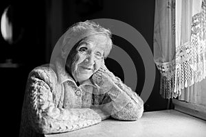 Portrait of an elderly woman near the window.