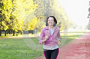 Portrait of elderly woman running in the park