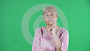 Portrait elderly woman thinking with concentration happy there is an idea. Gray haired grandmother with short hair in a