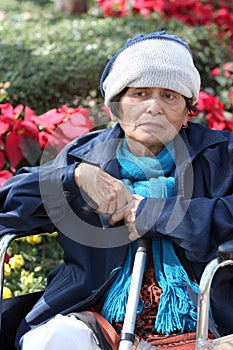 Portrait of elderly woman on trolley and cold weather.