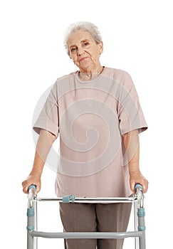 Portrait of elderly woman using walking frame isolated
