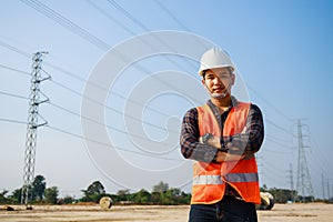 Portrait of Electrical Engineer, field engineer, foreman, owner standing in construction site project and Electric power line and