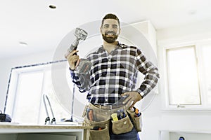 Portrait of an electrician happy worker at work install light