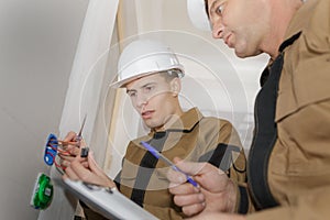 Portrait electrician installing socket in new house