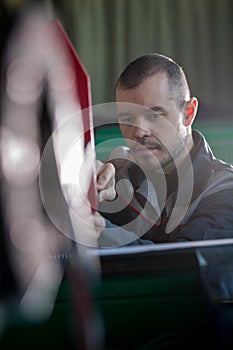 Portrait of electrician on overalls is working with energy panel and machinery equipment on plant - de-focused