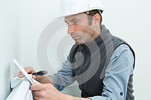 portrait electrician reading heater manual