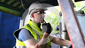 Portrait of an electrician working in an industry. Staff driving a forklift in an industrial factory