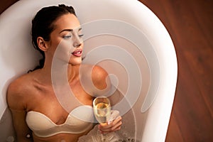 Portrait of elegant beautiful woman relaxing in a spa bath