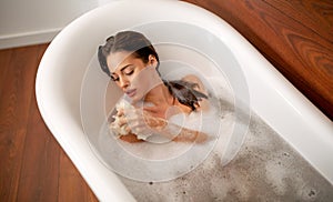 Portrait of elegant beautiful woman relaxing in a spa bath