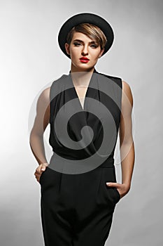 Portrait of elegant bussinesswoman wearing black clothes and a fashionable hat.