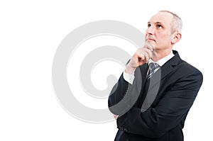 Portrait of elegant man standing making thinking gesture