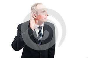 Portrait of elegant senior making can`t hear you gesture